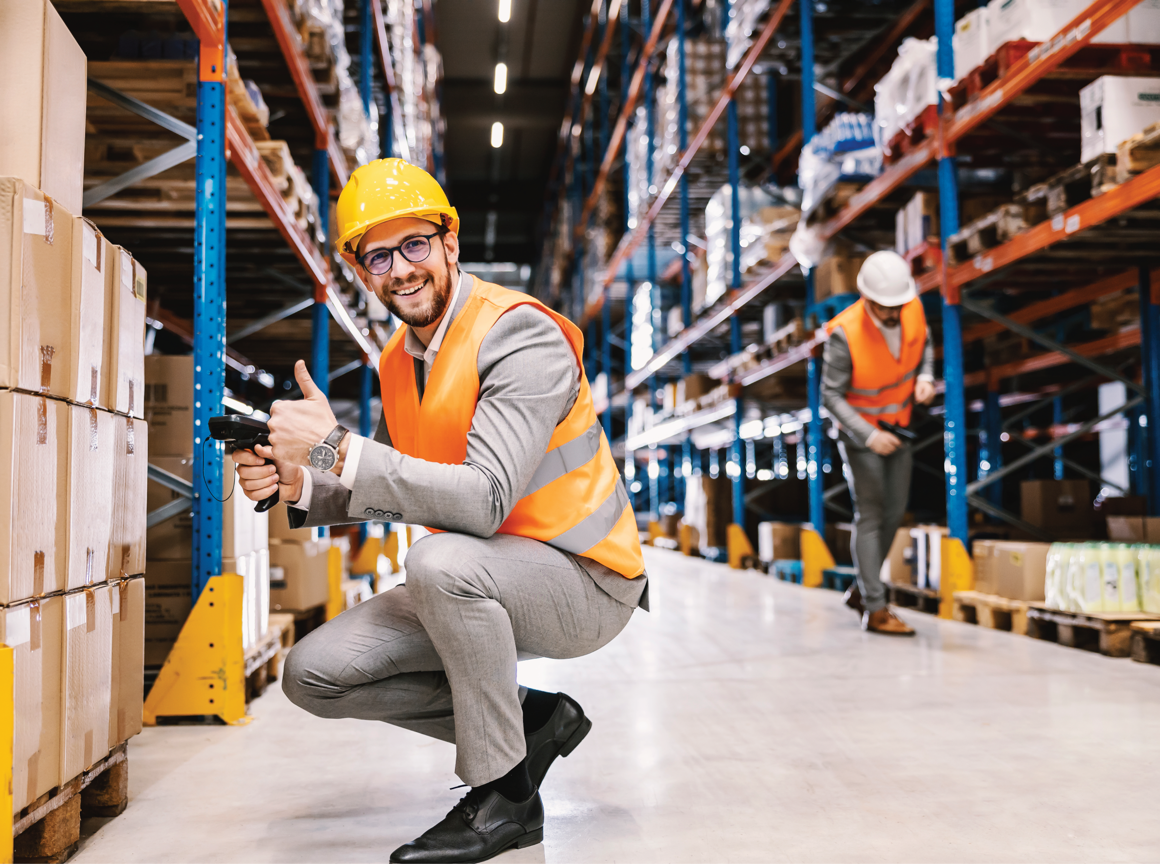 A supervisor giving thumbs up for order and holding bar and qr code scanner in warehouse.