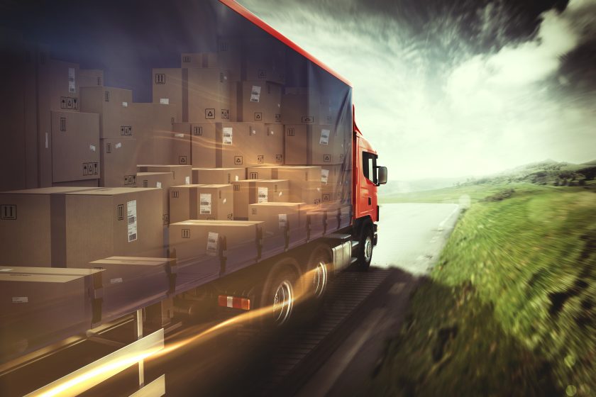 Truck on the road with load of boxes.